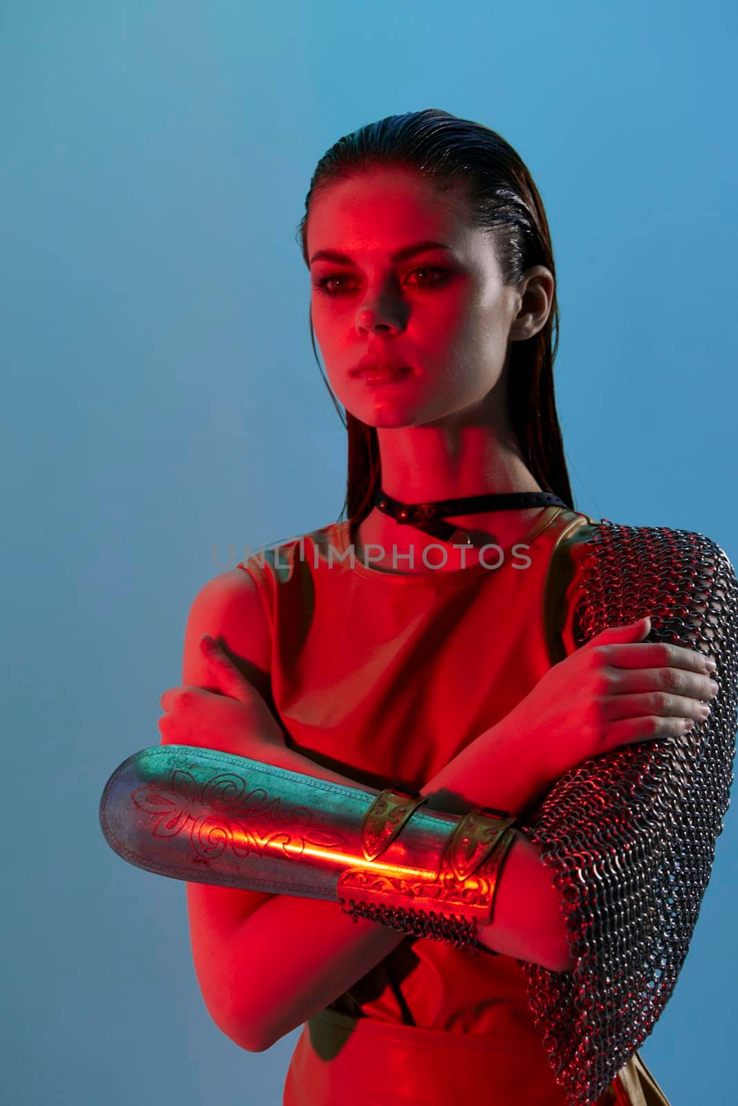 attractive woman Glamor posing red light metal armor on hand unaltered. High quality photo