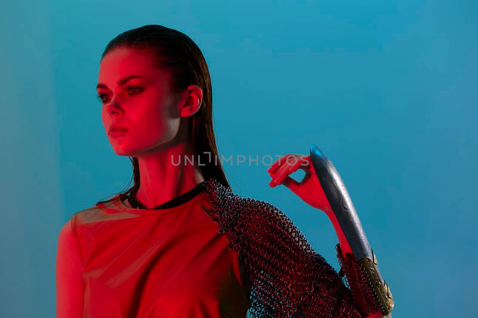 attractive woman Glamor posing red light metal armor on hand Lifestyle unaltered. High quality photo