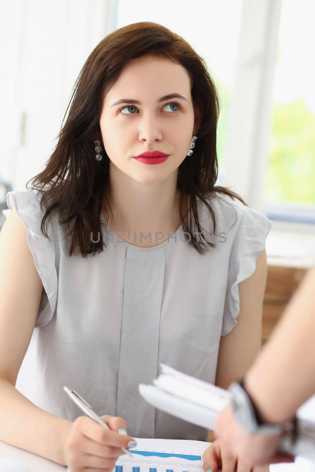 Pretty brunette female office worker listen to coworker ideas, colleagues discuss working moment by kuprevich