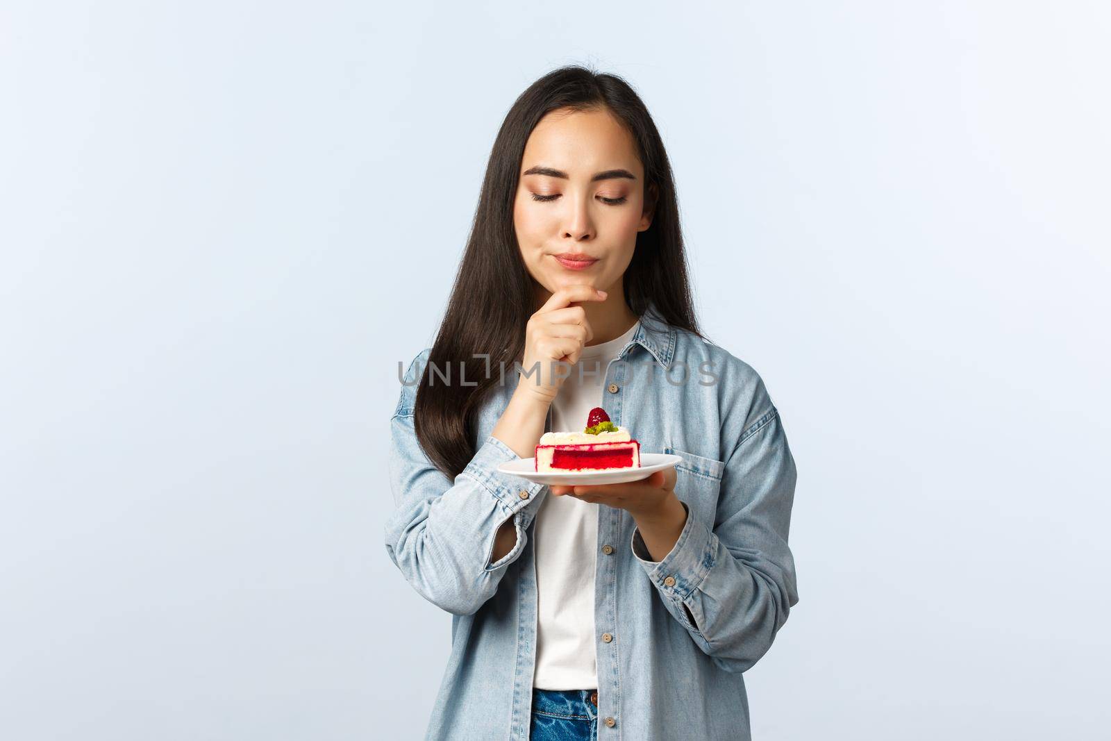 Social distancing lifestyle, covid-19 pandemic, celebrating holidays during coronavirus concept. Thoughtful serious-looking b-day girl thinking focused what wish make on birthday by Benzoix