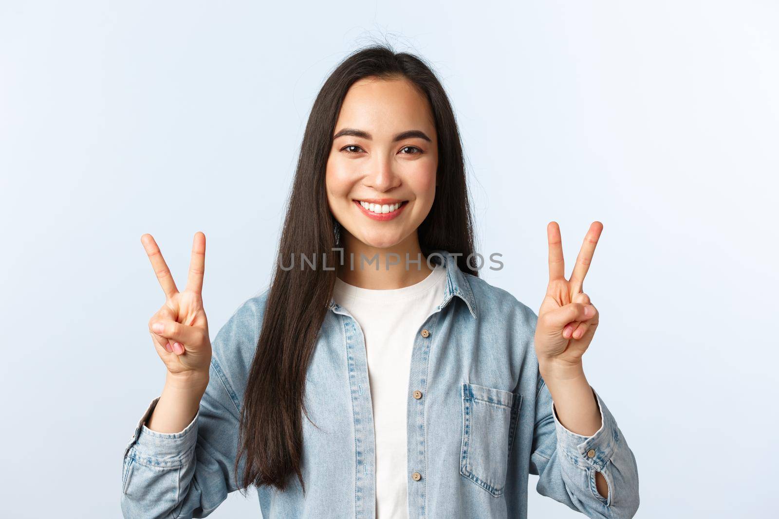 Lifestyle, people emotions and beauty concept. Friendly optimistic kawaii girl, asian female student in casual outfit showing v-sign, peace gesture over white background by Benzoix