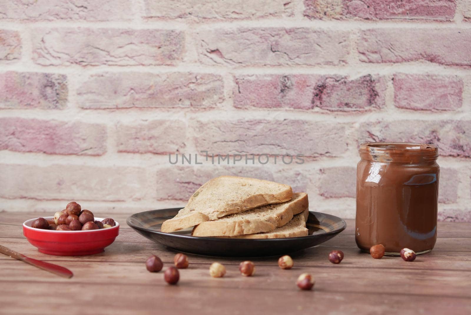 Chocolate Hazelnut cream in a container on table .