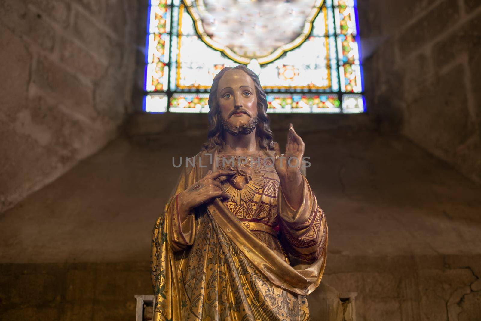 Statue of Jesus with a red heart in a church