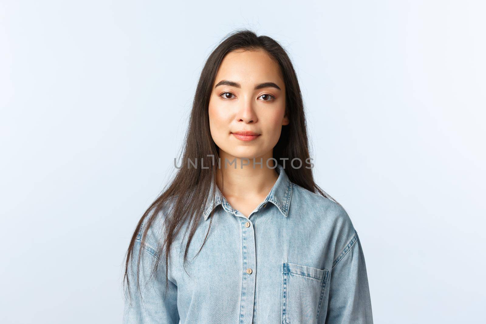 Lifestyle, people emotions and beauty concept. Cheerful asian girl in casual outfit looking camera with pleased smile, employee start first day new job, shop clerk listening customer.