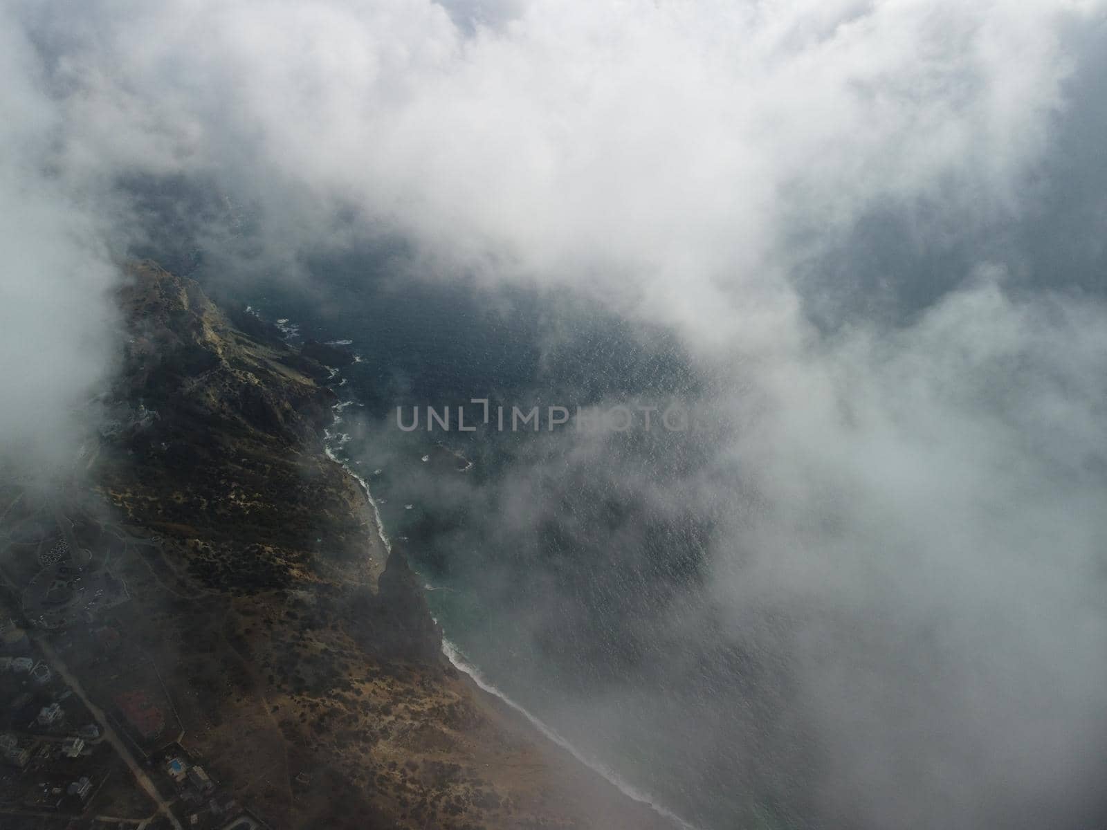 Aerial view. The drone flies over foggy and fluffy clouds. Blue sky sun and sea fog. Abstract aerial nature summer ocean sunset sea and sky background. Vacation, vacation and holiday concept by panophotograph