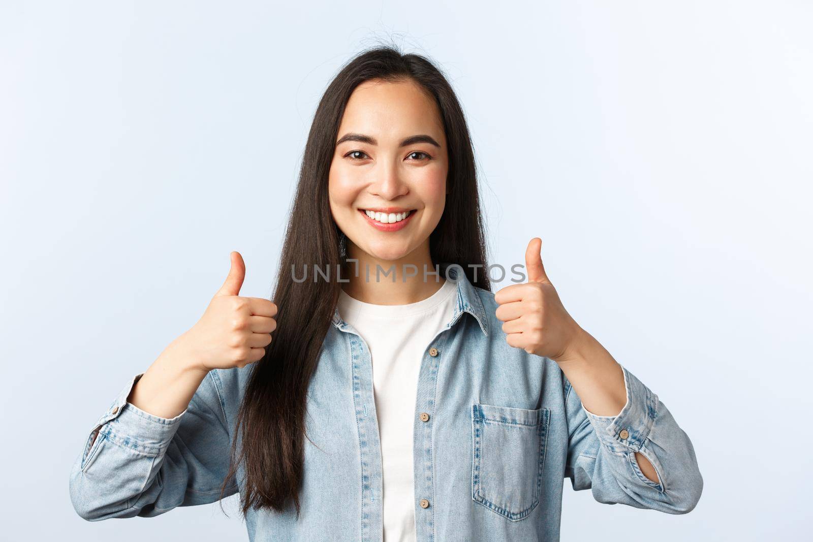 Lifestyle, people emotions and beauty concept. Satisfied pretty asian girl in casual outfit thumbs-up in approval, like and agree, support friends choice, encourage or recommend smth by Benzoix