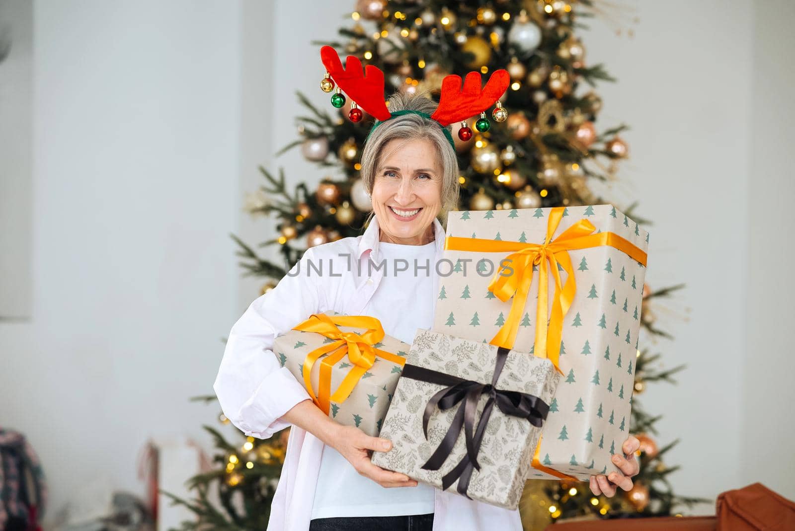 Grandma wearing deer christmas hat, happy smiling face.