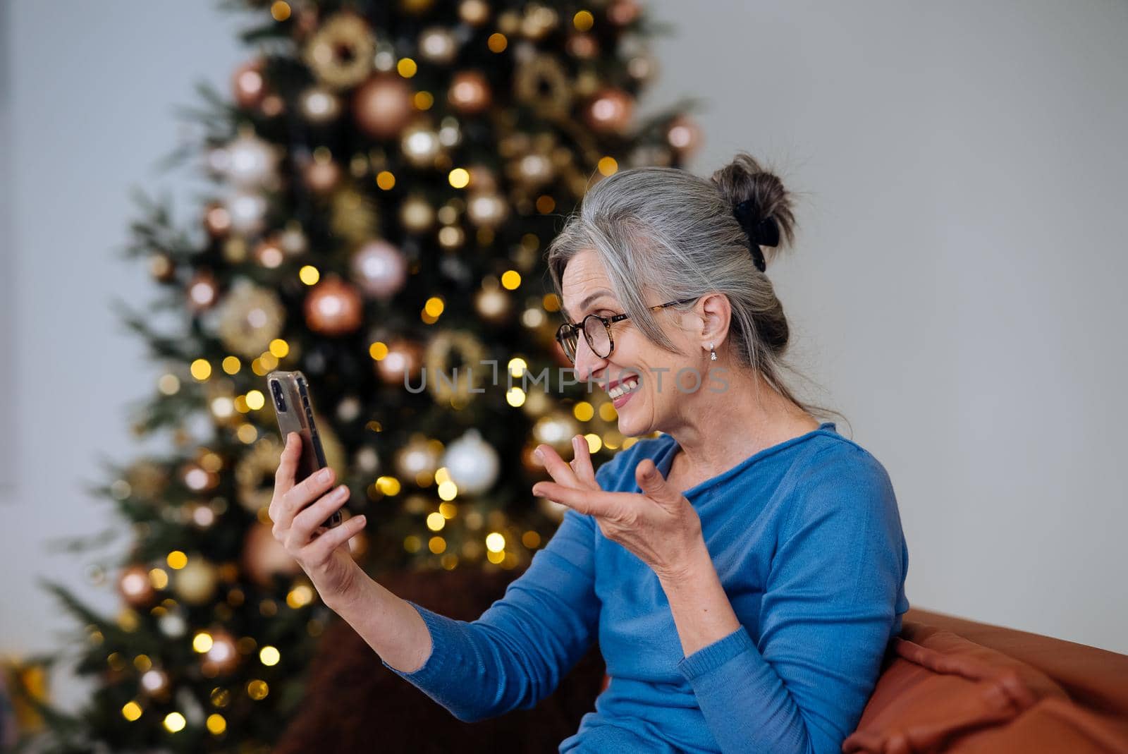 Happy smiley face senior elderly woman using smartphone video call conference camera and talking with family.Video chat social distancing.