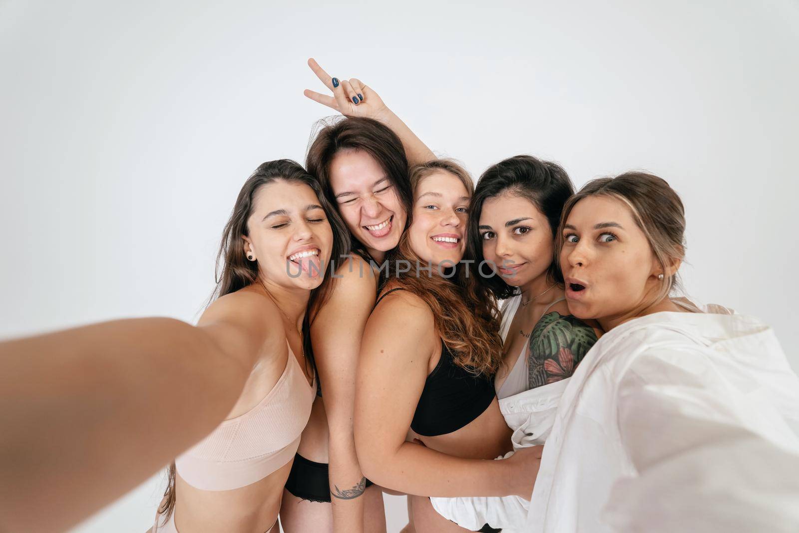 Diverse models wearing comfortable underwear take selfie, look at camera having smile and natural unique beauty