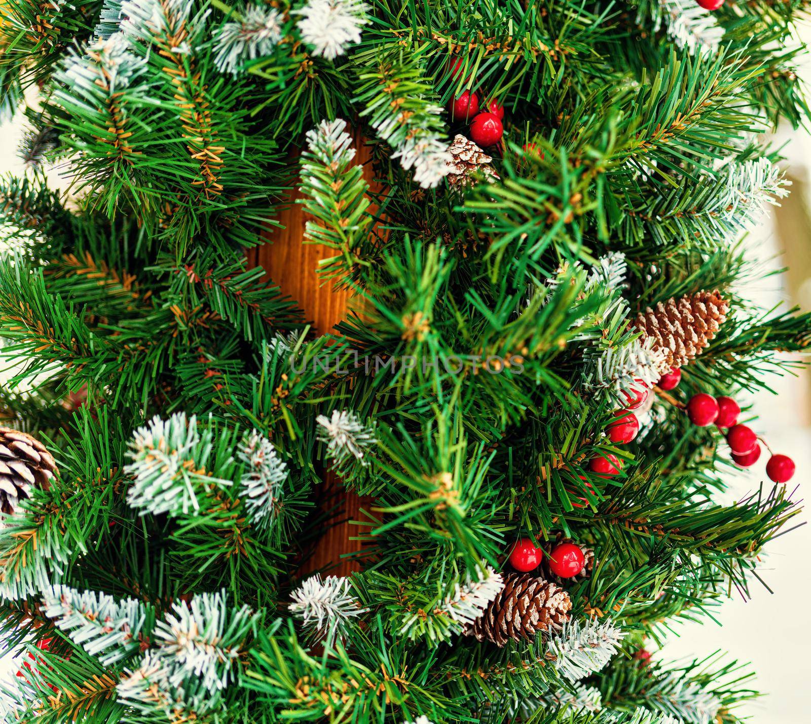 Christmas toy cones and berries on an artificial spruce. Xmas abstract background.                           