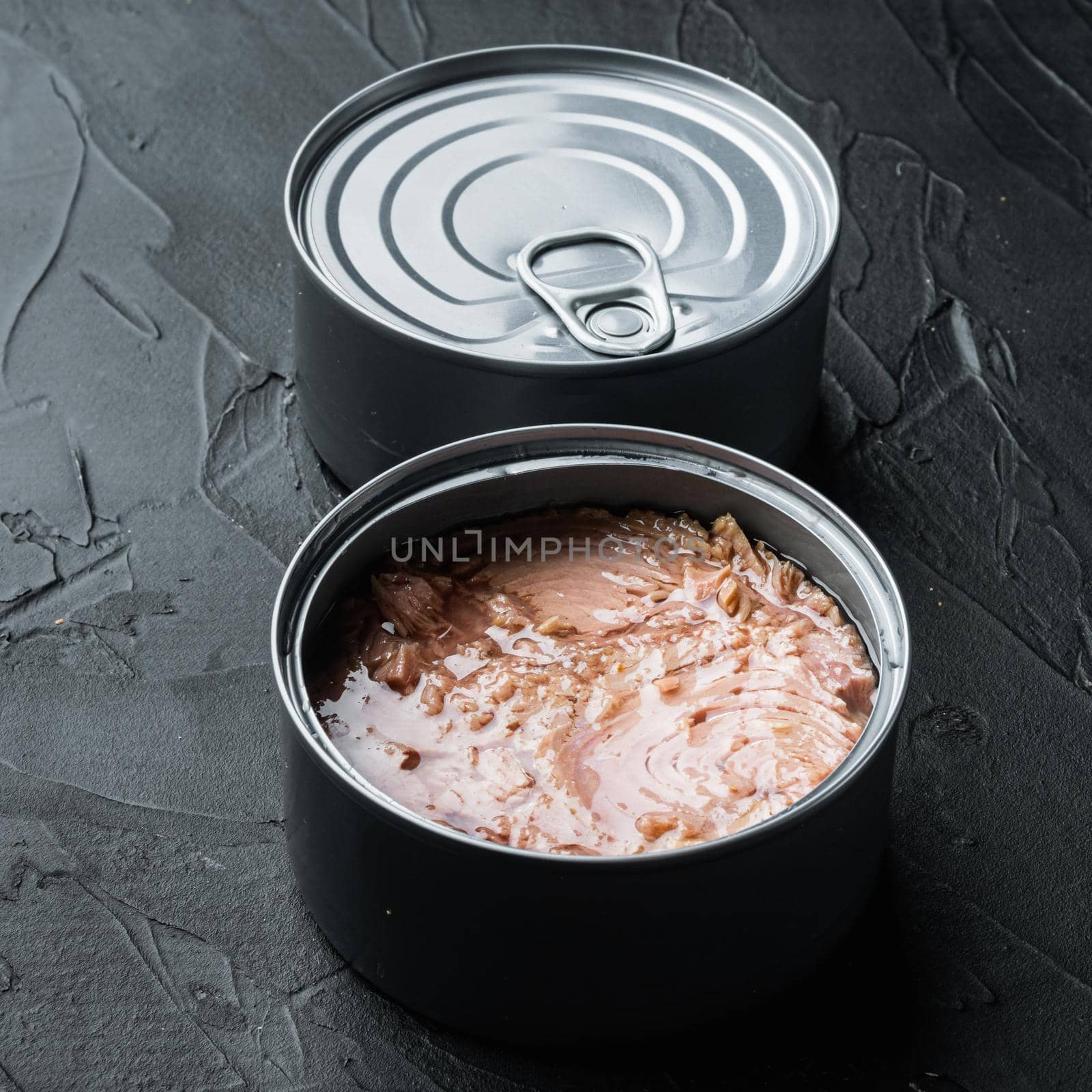 Canned Chunk Light Tuna, in tin can, on black background by Ilianesolenyi