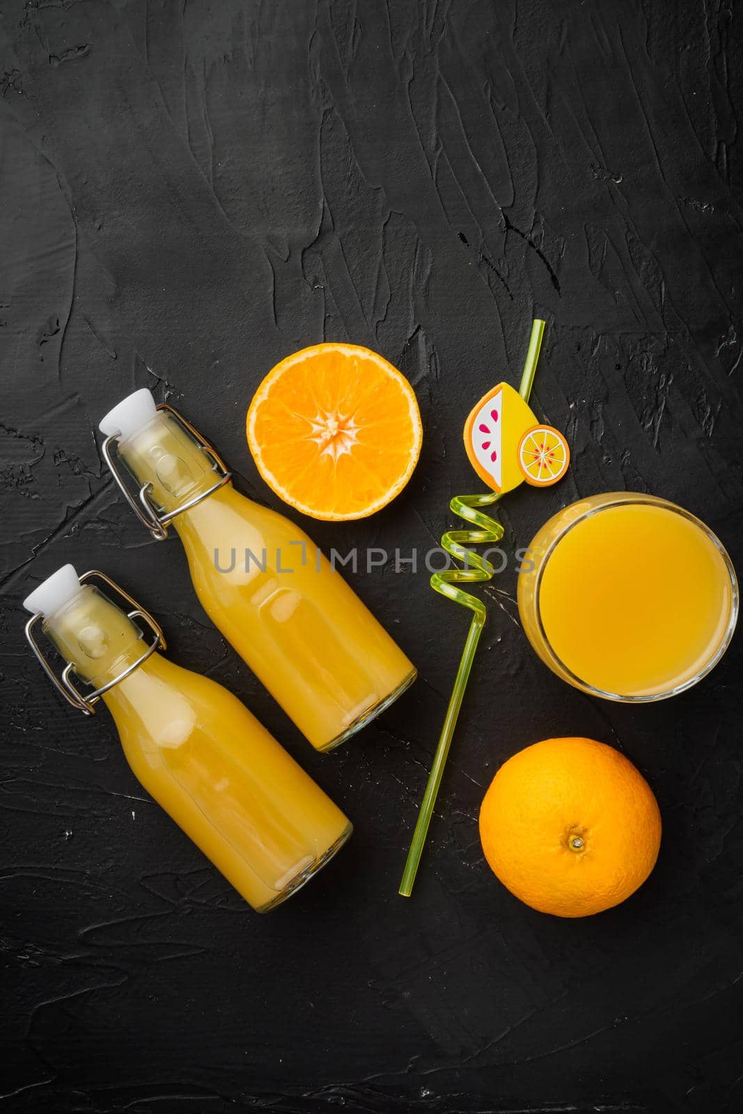 Tangerine juice set, on black dark stone table background, top view flat lay