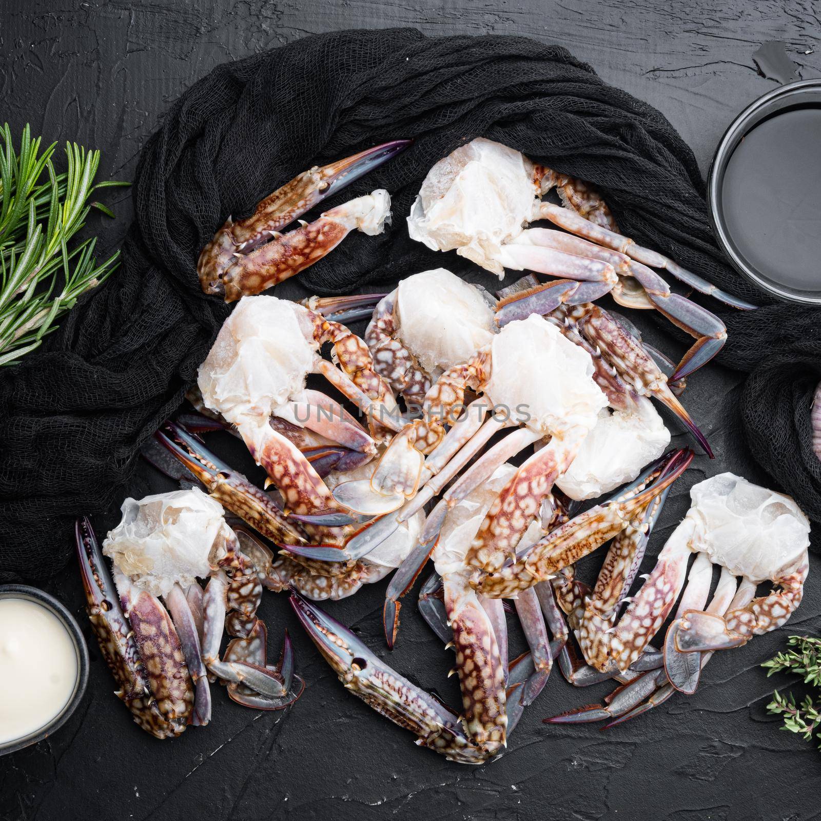 Fresh blue swimming crab Horse crab, Blue crab, Flower crab claws set, on black background, top view flat lay