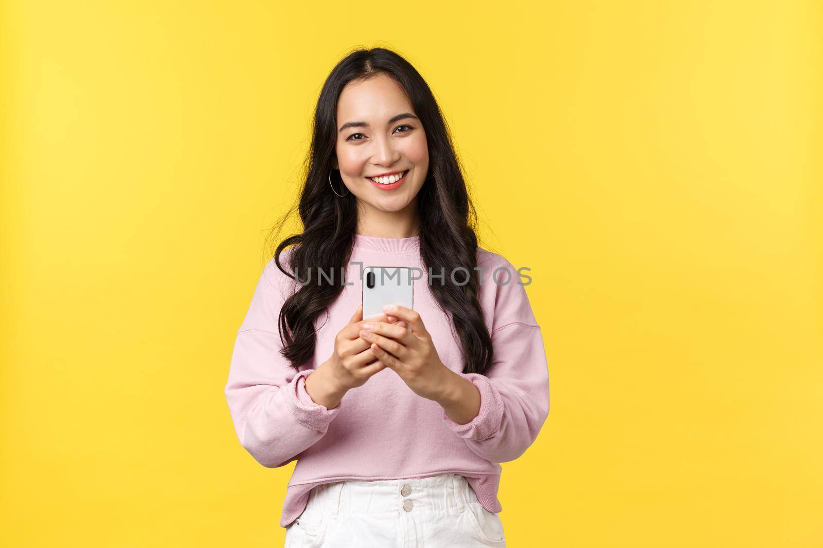 People emotions, lifestyle leisure and beauty concept. Kawaii smiling asian woman taking picture on smartphone, using photo filters to edit post in application, using mobile phone by Benzoix