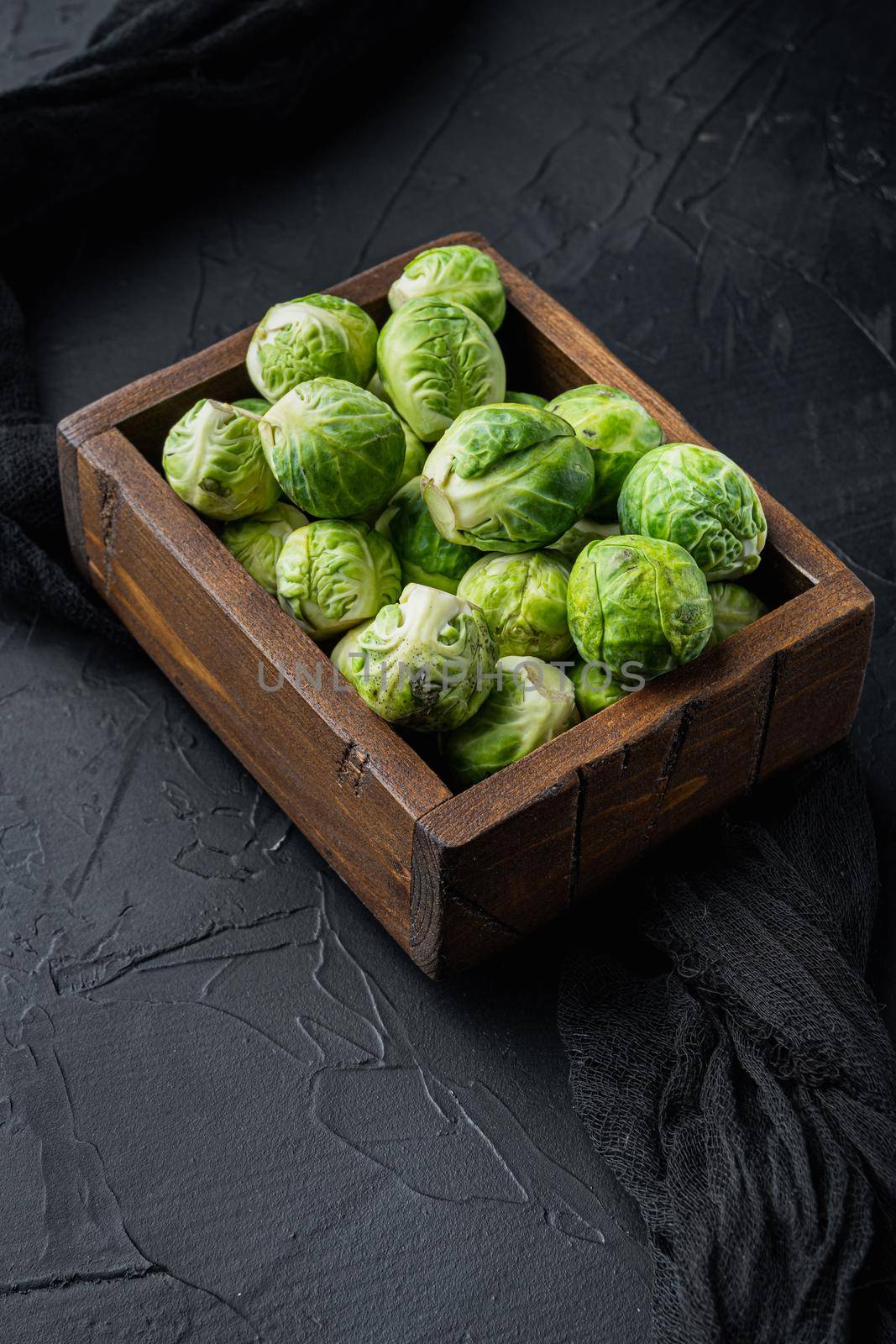 Brussels sprouts, on black textured background by Ilianesolenyi