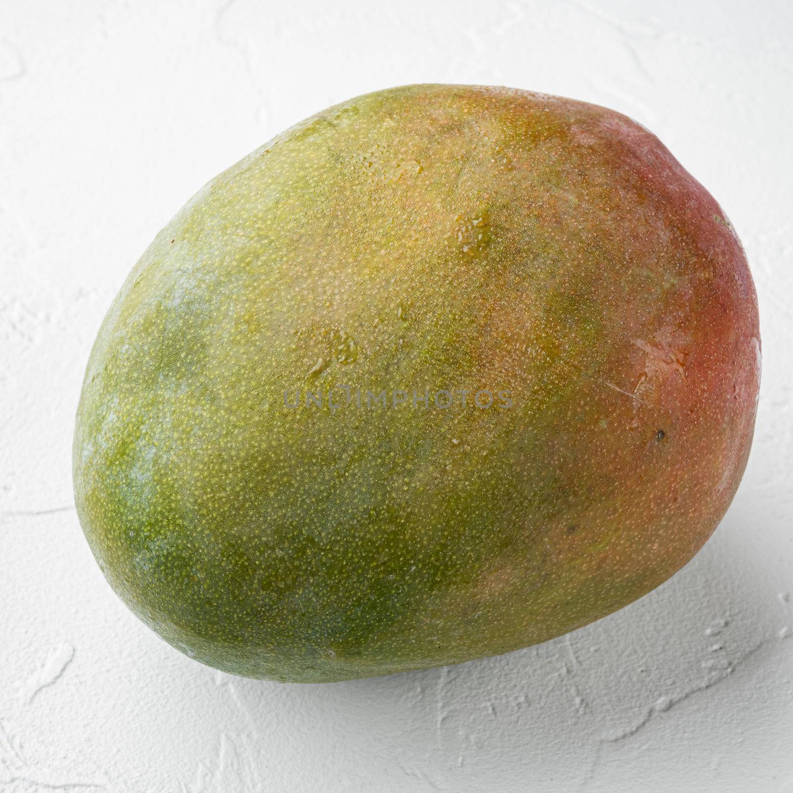 Mango whole fruit, on white stone table background, square format by Ilianesolenyi