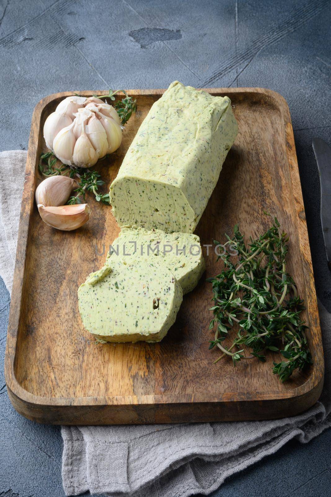 Fresh green herb butter, on gray stone background by Ilianesolenyi