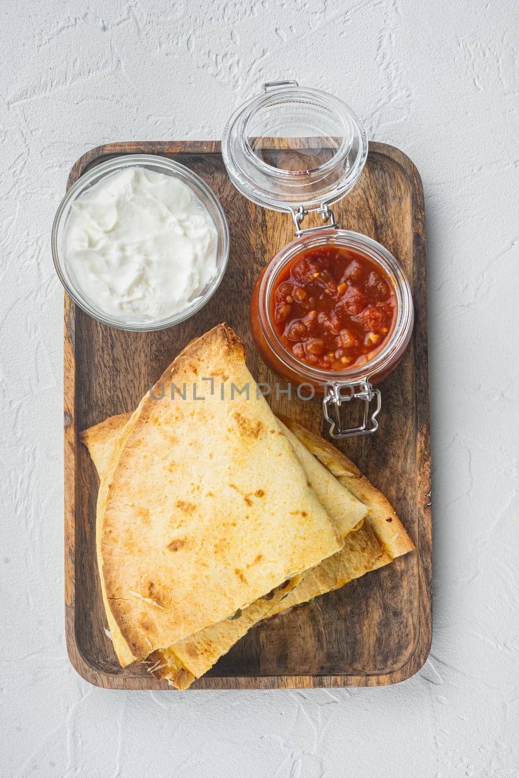 Mexican quesadilla wrap with chicken, corn and sweet pepper and salsa sauce, on white background, top view flat lay