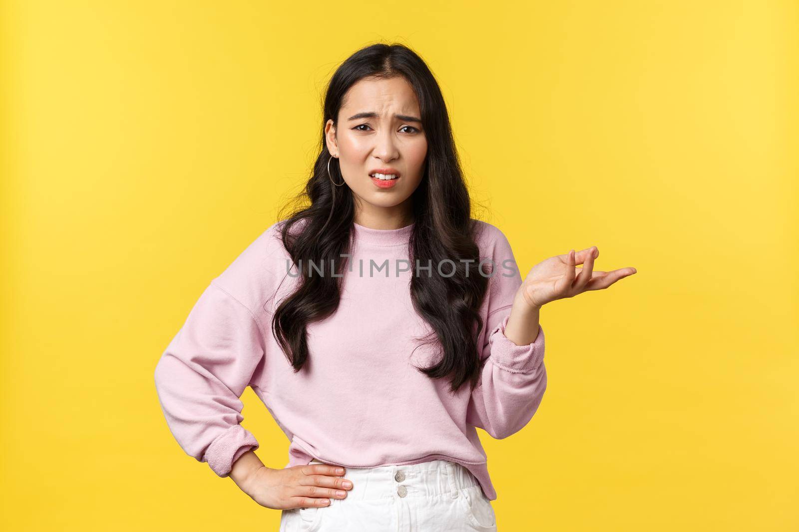 People emotions, lifestyle and fashion concept. Confused and unimpressed korean girl in stylish outfit, arguing, having conversation, shrugging with hand raised in dismay, look skeptical by Benzoix