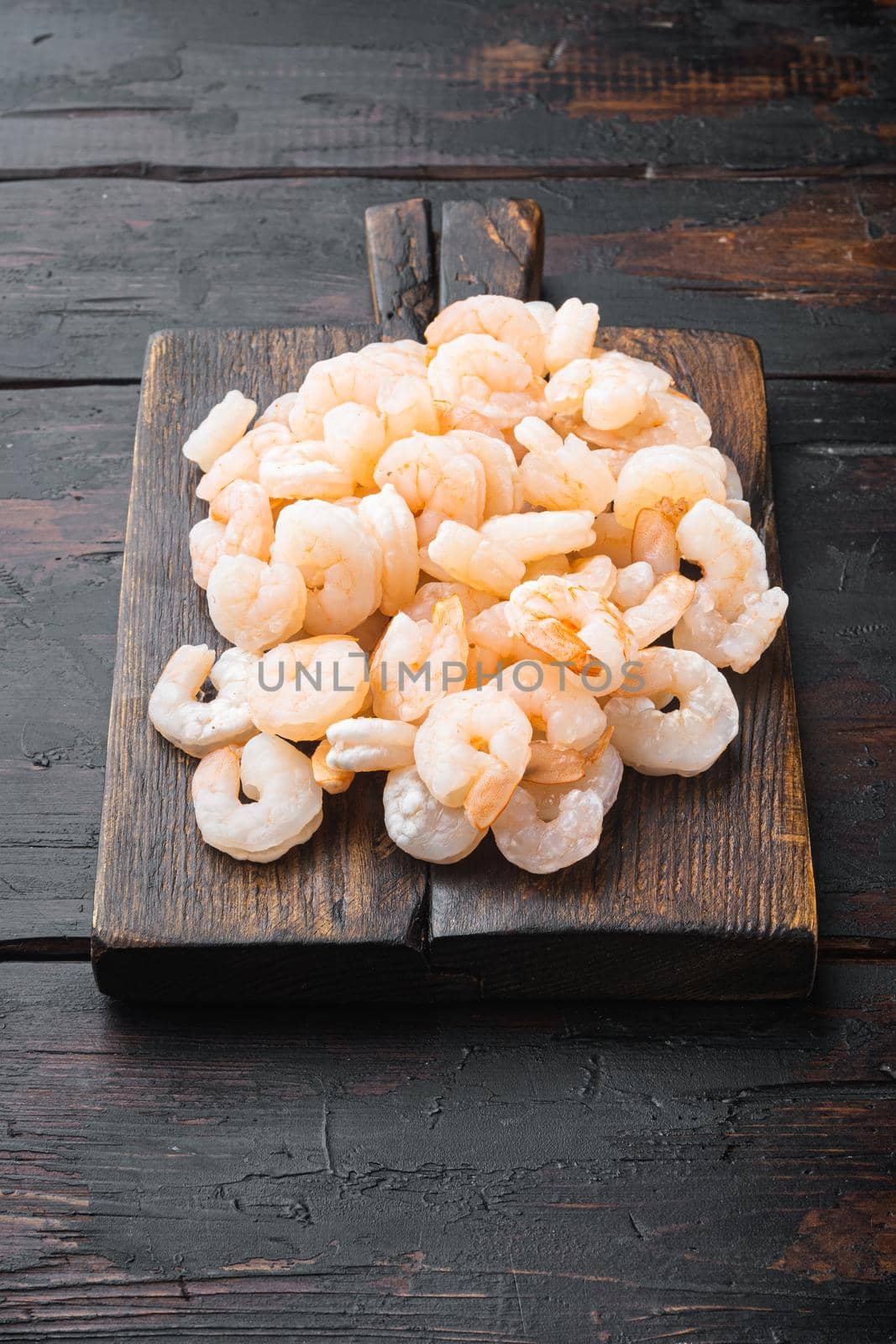 Boiled Peeled Shrimps, Prawns set, on wooden serving board, on old dark wooden table