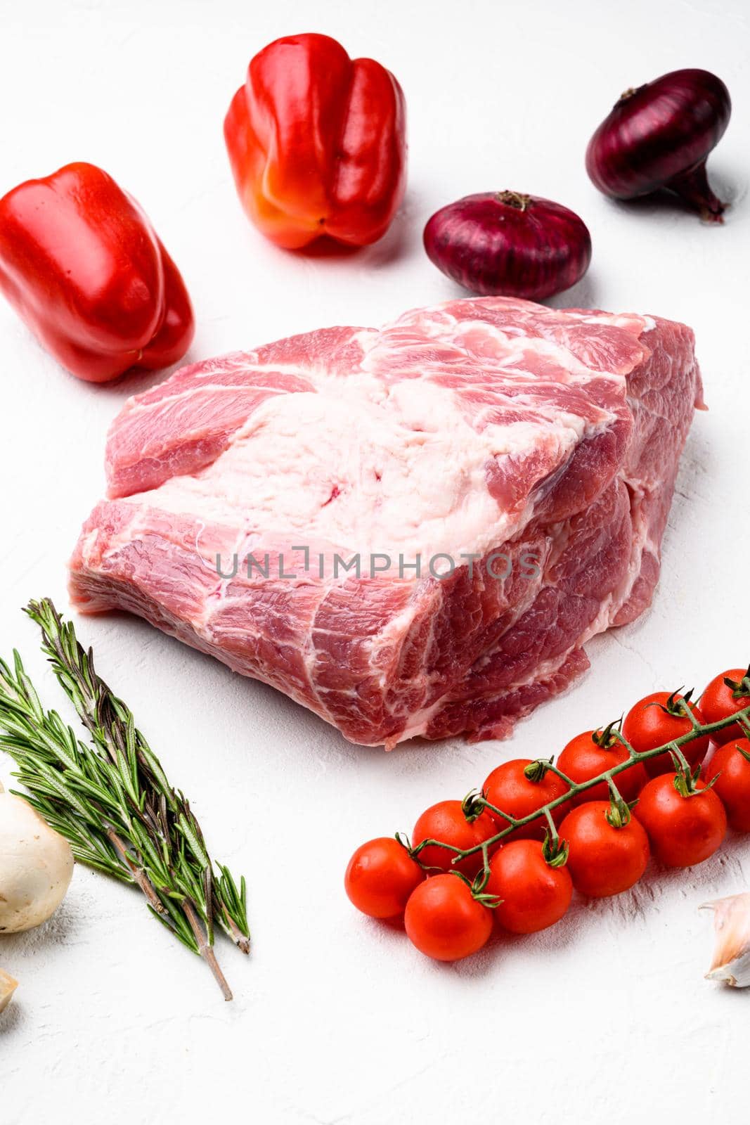 Pork meat raw neck, with ingredients and herbs, on white stone table background by Ilianesolenyi