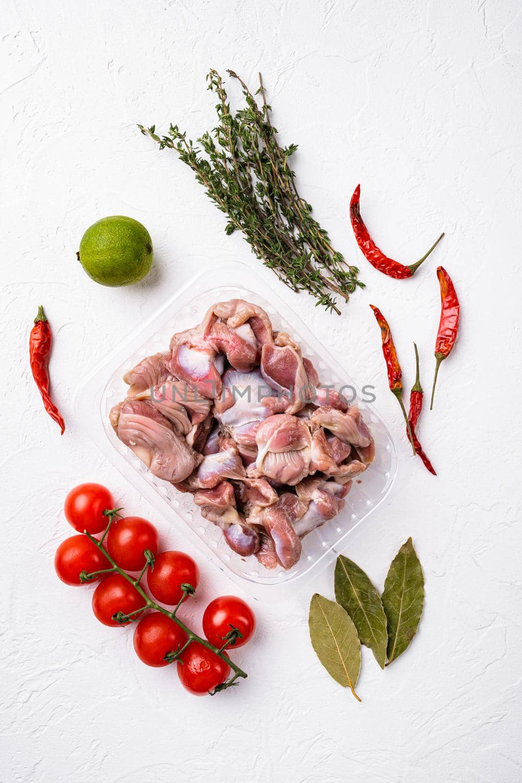 Chicken stomach container, on white stone table background, top view flat lay by Ilianesolenyi