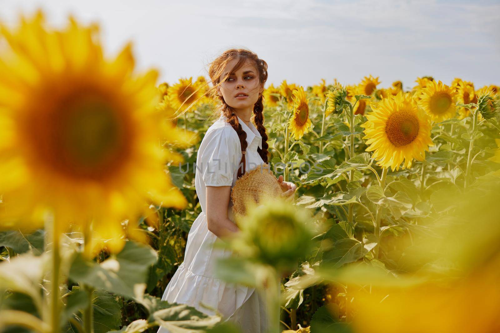 woman with pigtails in a white dress admires nature unaltered. High quality photo