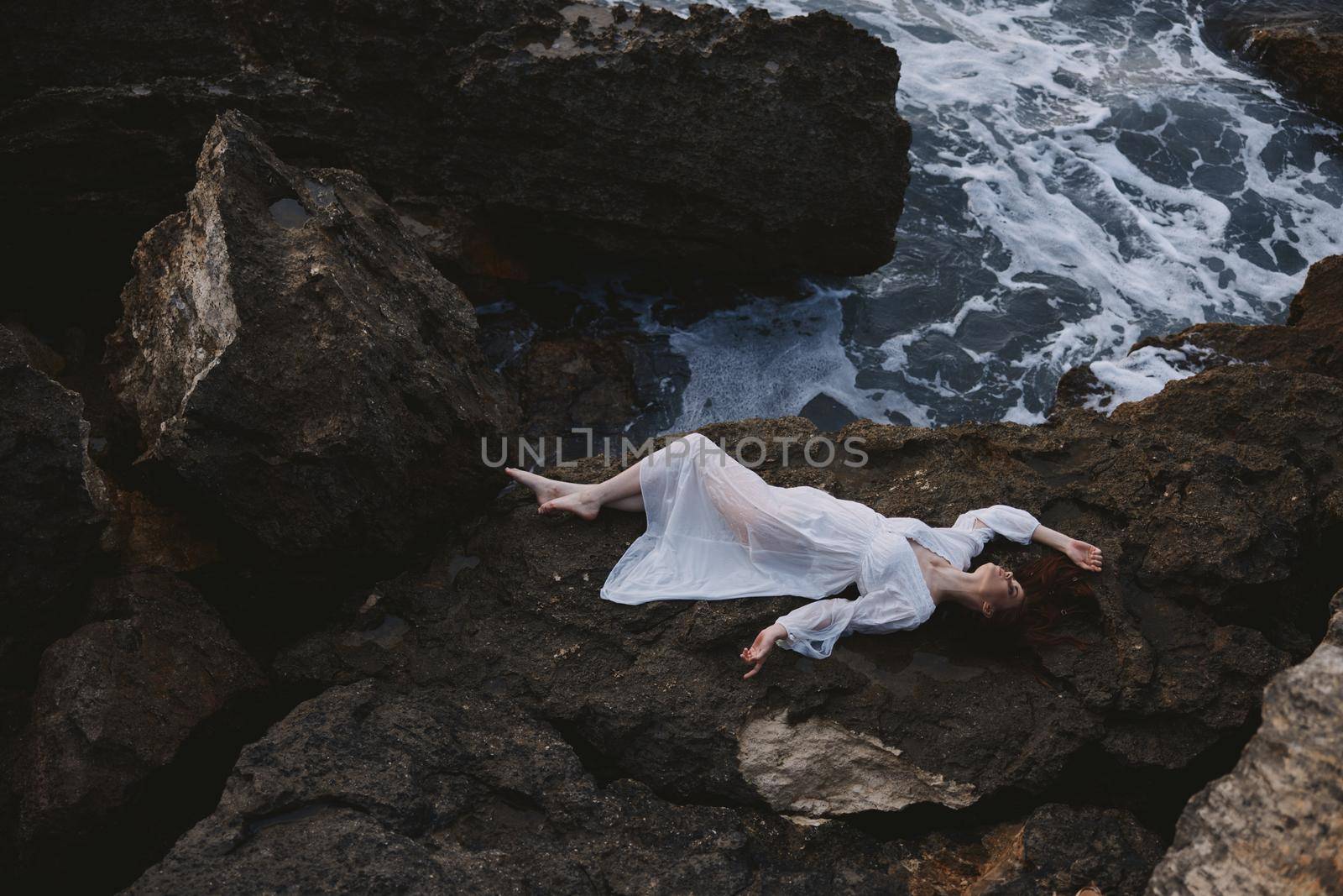 Beautiful bride in white wedding dress on sea shore wet hair nature. High quality photo