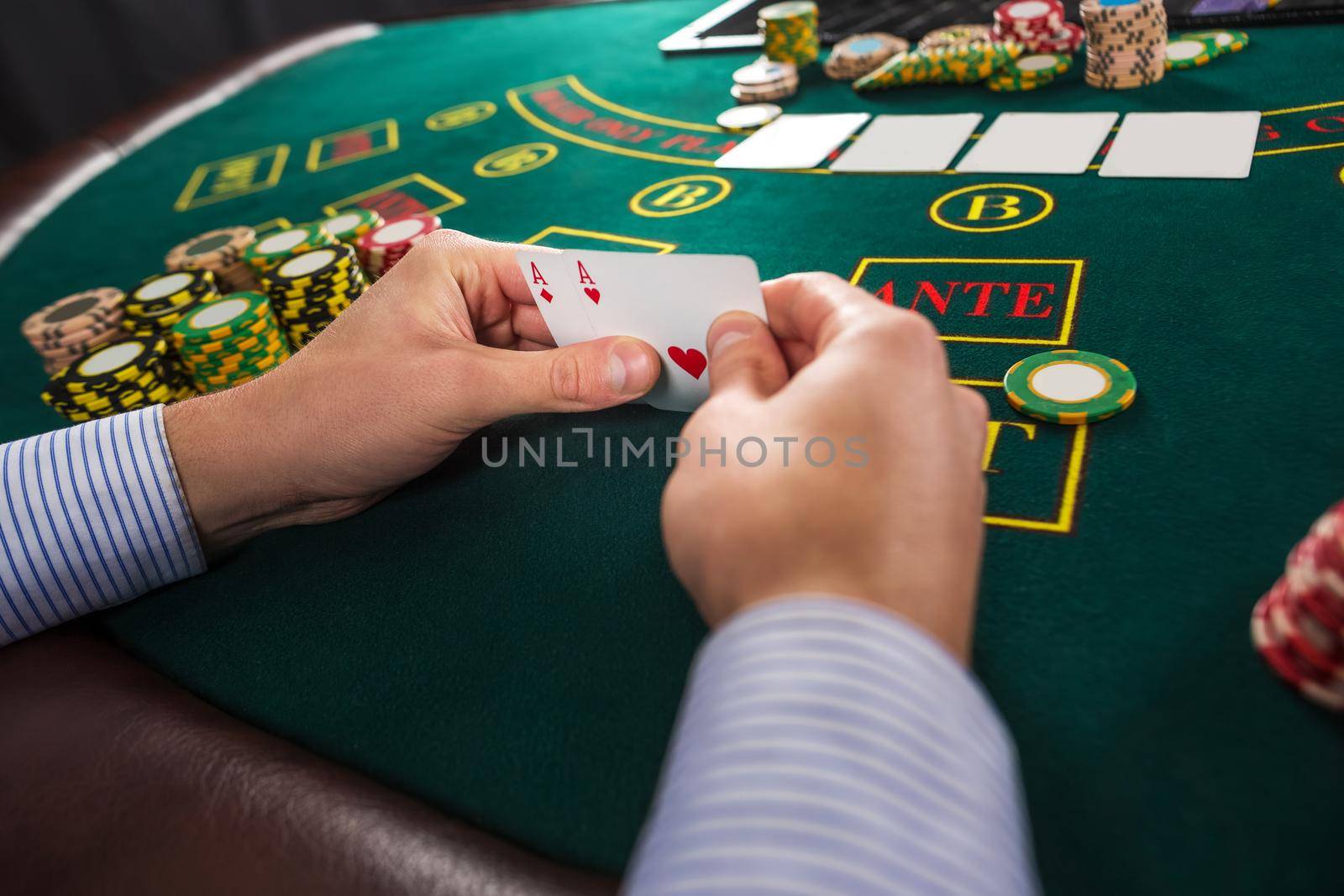 Male poker player holding the of two cards aces by nazarovsergey