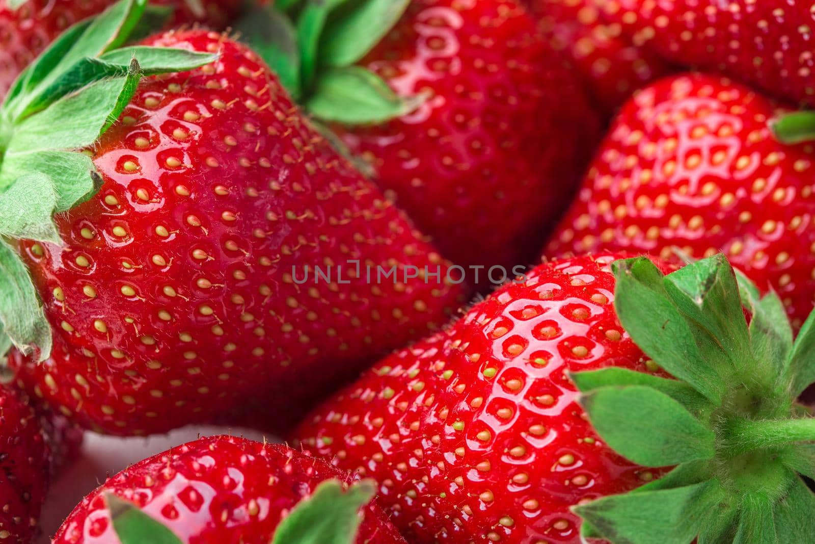 Red Strawberry, red close up strawberries with selective focus on a strawberry with many strawberries in the background for food or fruit close up background or strawberry texture.