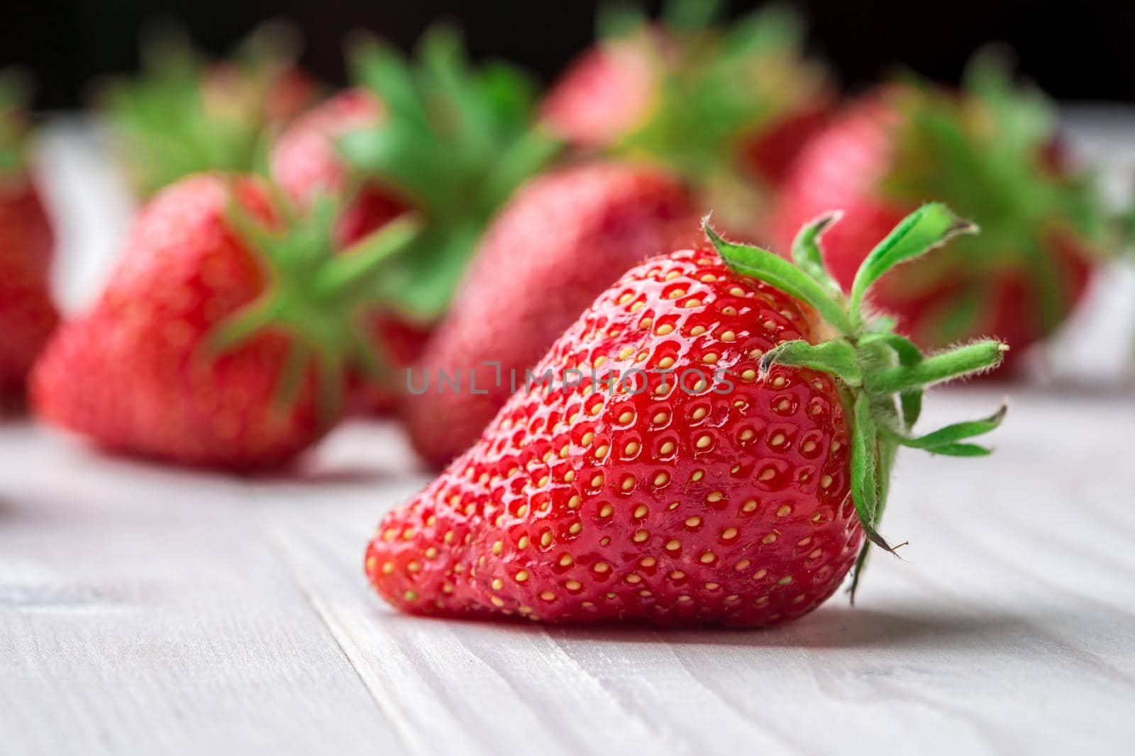 Fresh strawberry background. Ripe in close-up. by nazarovsergey