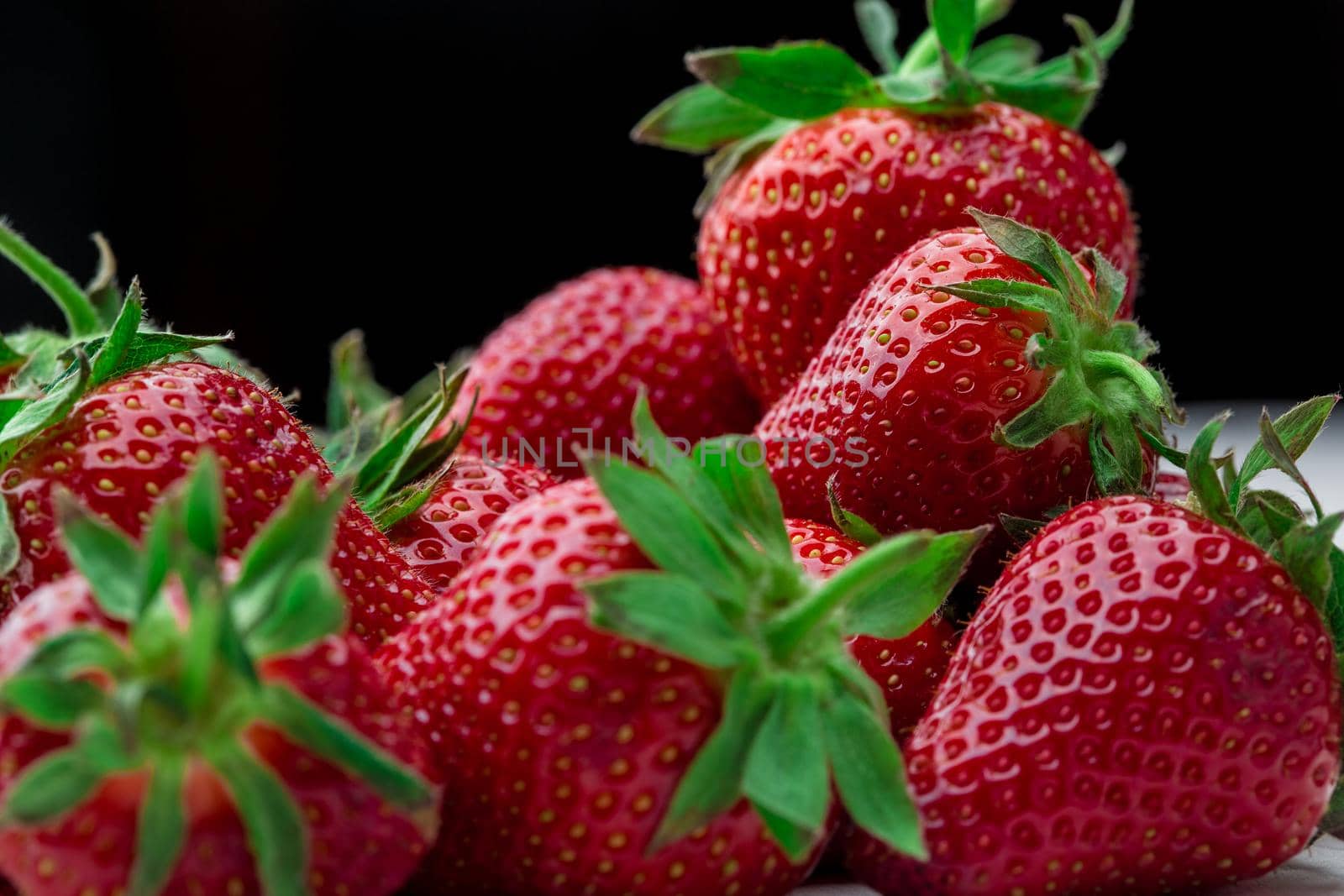 Red Strawberry, red close up strawberries with selective focus on a strawberry with many strawberries in the background for food or fruit close up background or strawberry texture.