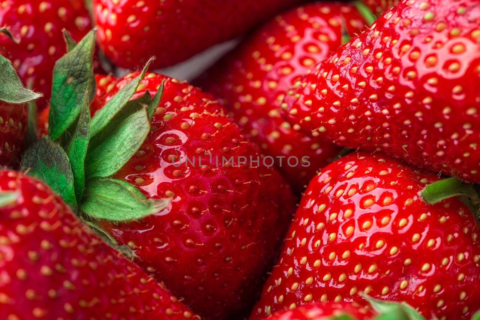 Red Strawberry, red close up strawberries with selective focus on a strawberry with many strawberries in the background for food or fruit close up background or strawberry texture.