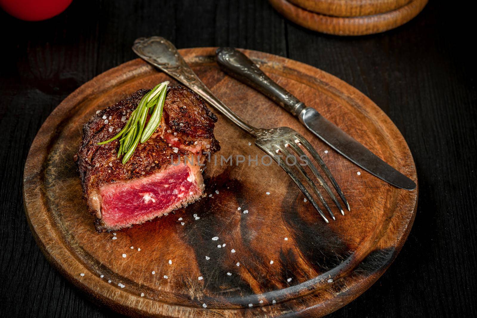 Grill juicy beef steak with salt pepper and rosemary. by nazarovsergey