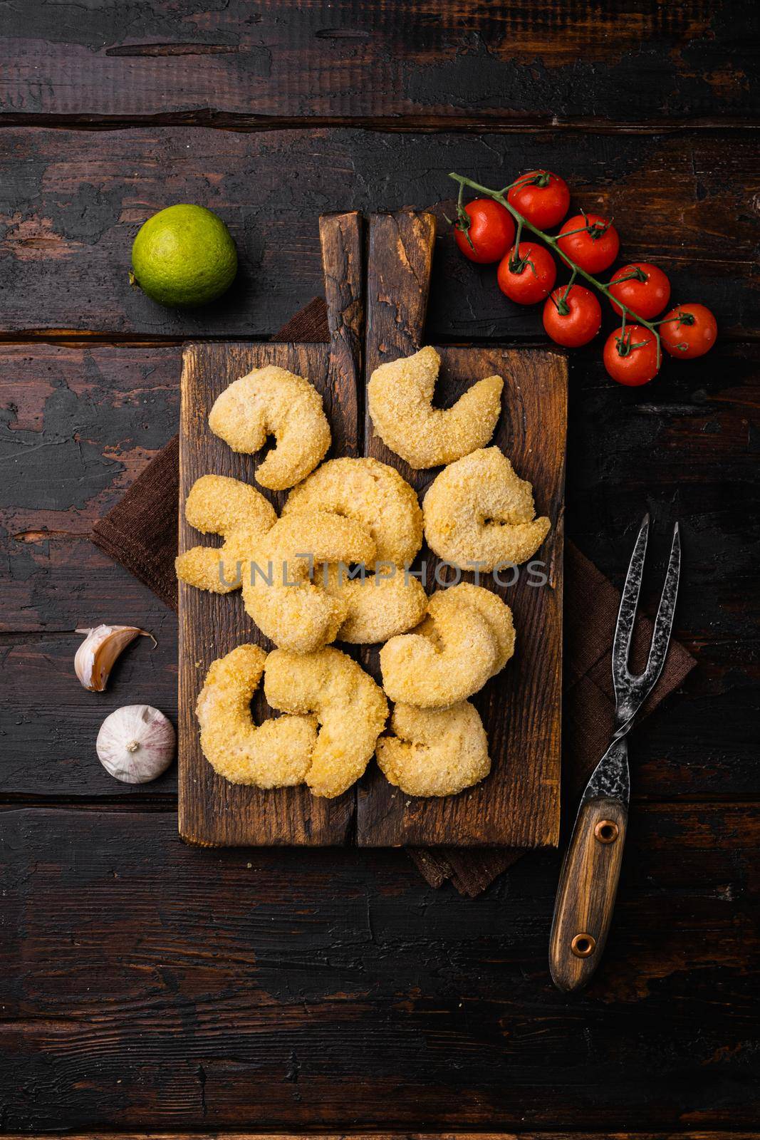 Breaded Deep Fried shrimps set, on old dark wooden table background, top view flat lay, with copy space for text