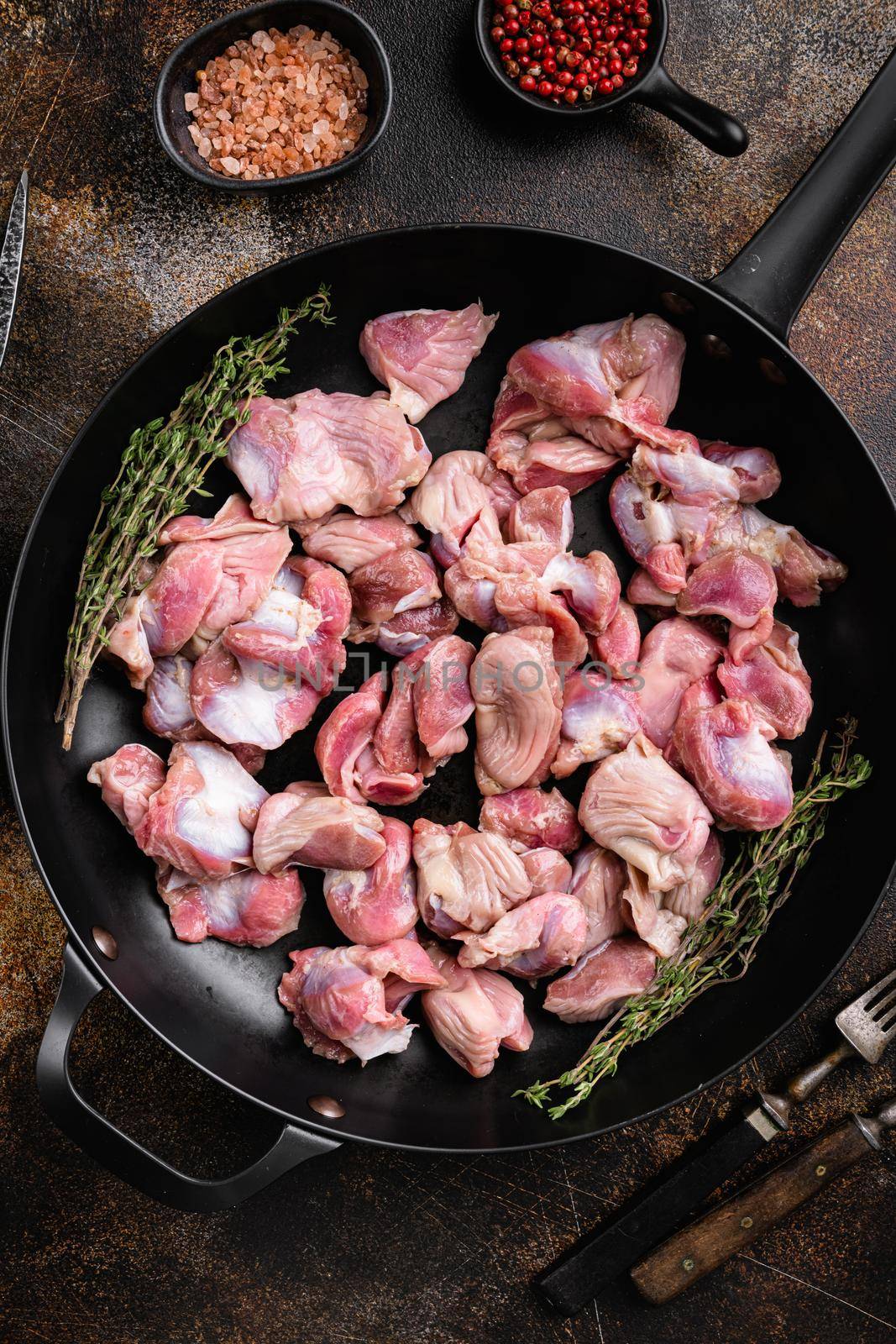Bird turkey giblets gizzards stomachs. Raw uncooked meat set, on old dark rustic table background, top view flat lay