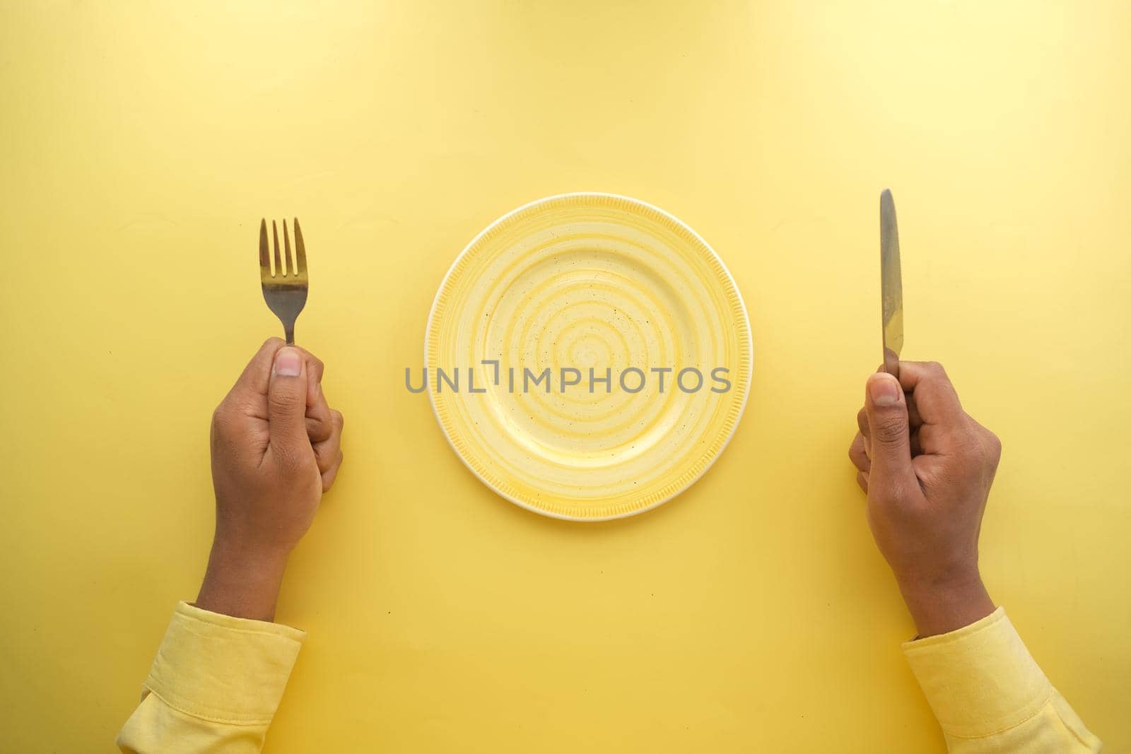 cutlery and empty plate on wooden background