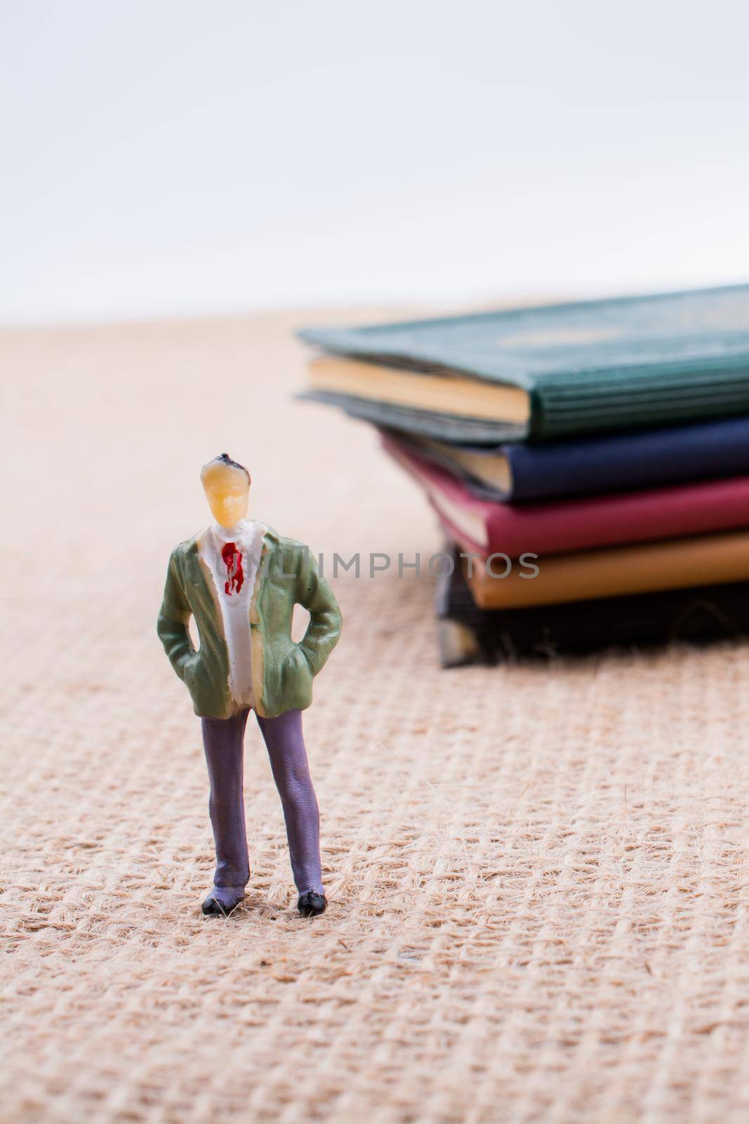 Man figurine standing inside the pages of the  book