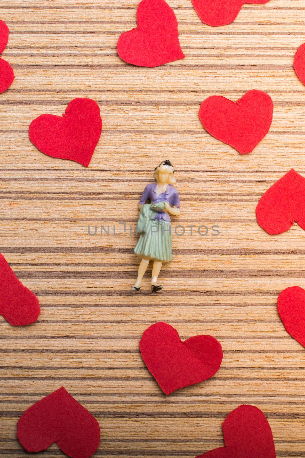 Woman figurine and Love concept with paper hearts  by berkay