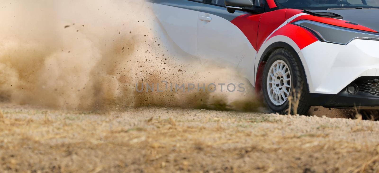 Rally race car drifting on dirt track.