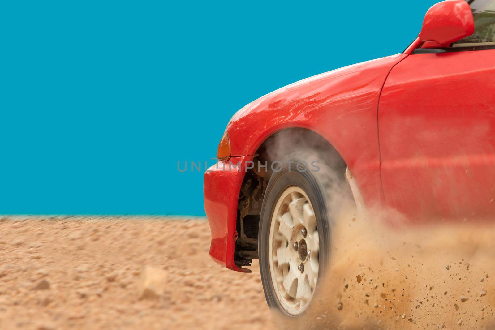 Rally race car drifting on dirt track.