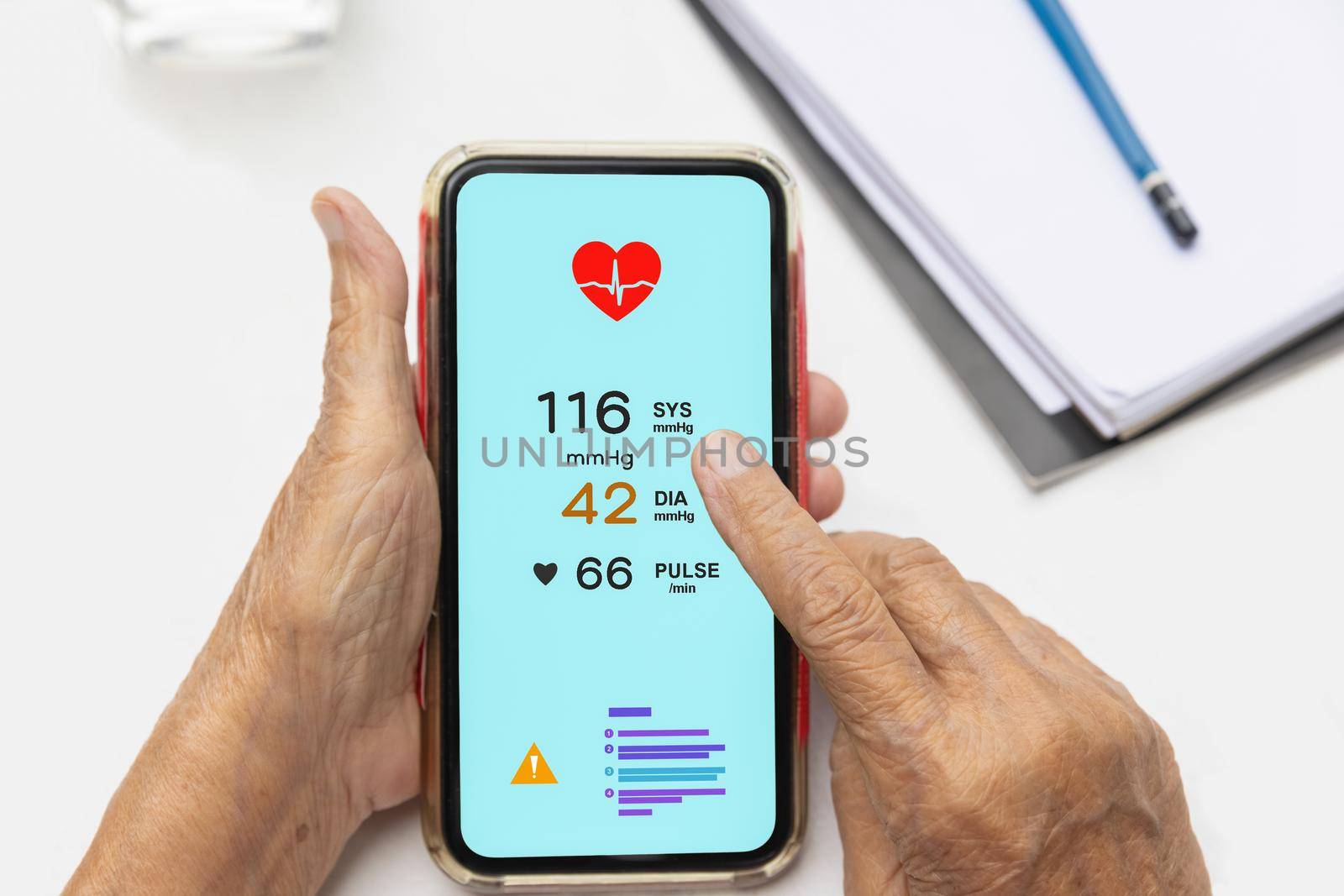 Senior woman checking blood pressure (hypertension) vai mobile phone by toa55