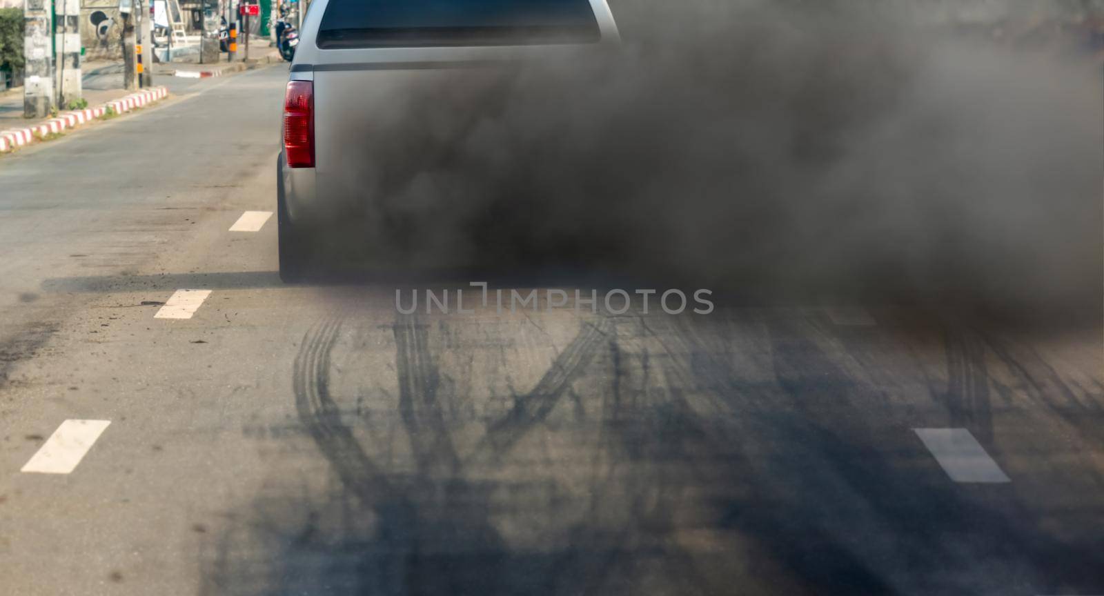 air pollution crisis in city from diesel vehicle exhaust pipe on road by toa55