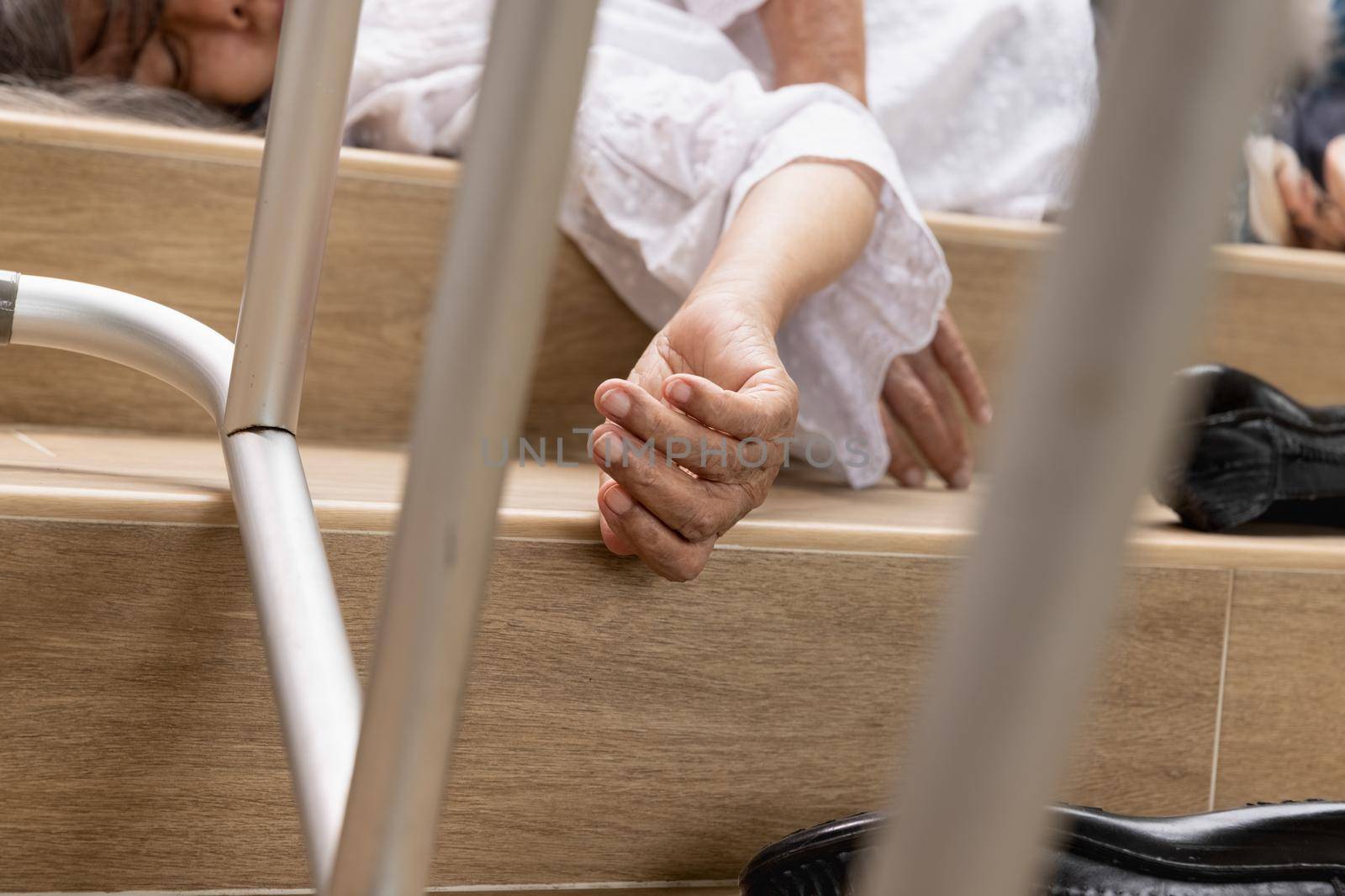 Elderly woman with walker falling down stair