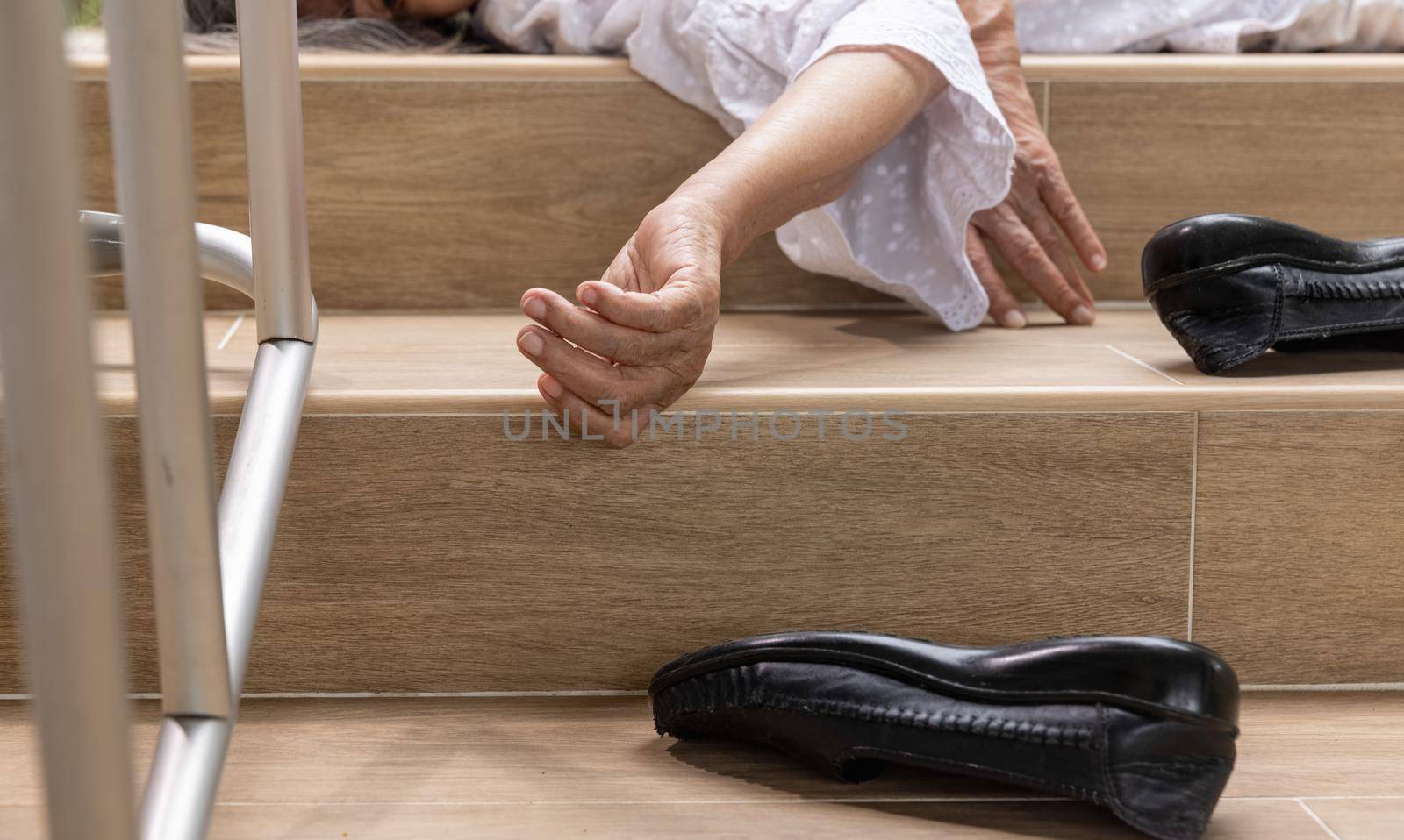 Elderly woman with walker falling down stair