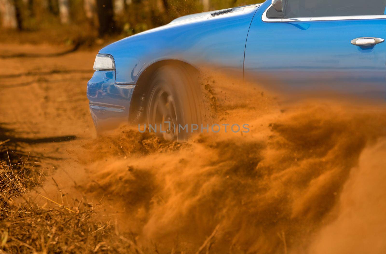 Rally race car drifting on dirt track.