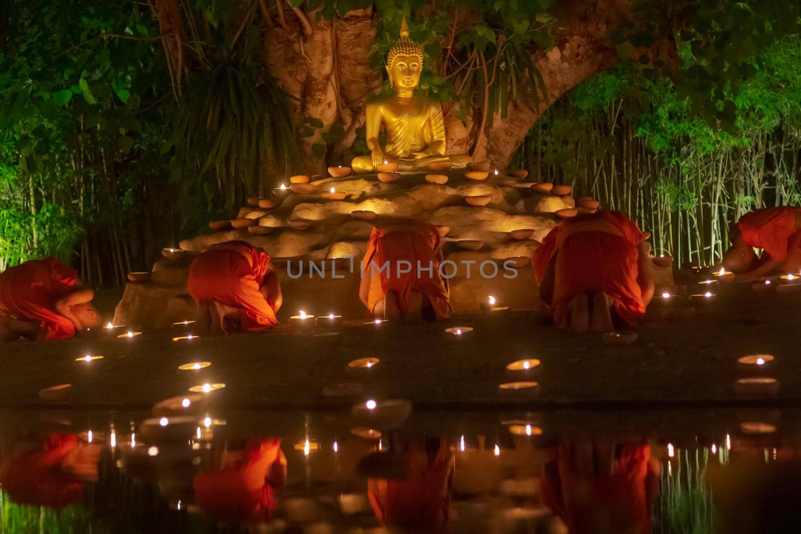 Visakha Puja Day (Vesak). Buddhist monk fire candles and pray to the Buddha in  Chiang Mai Thailand. by toa55