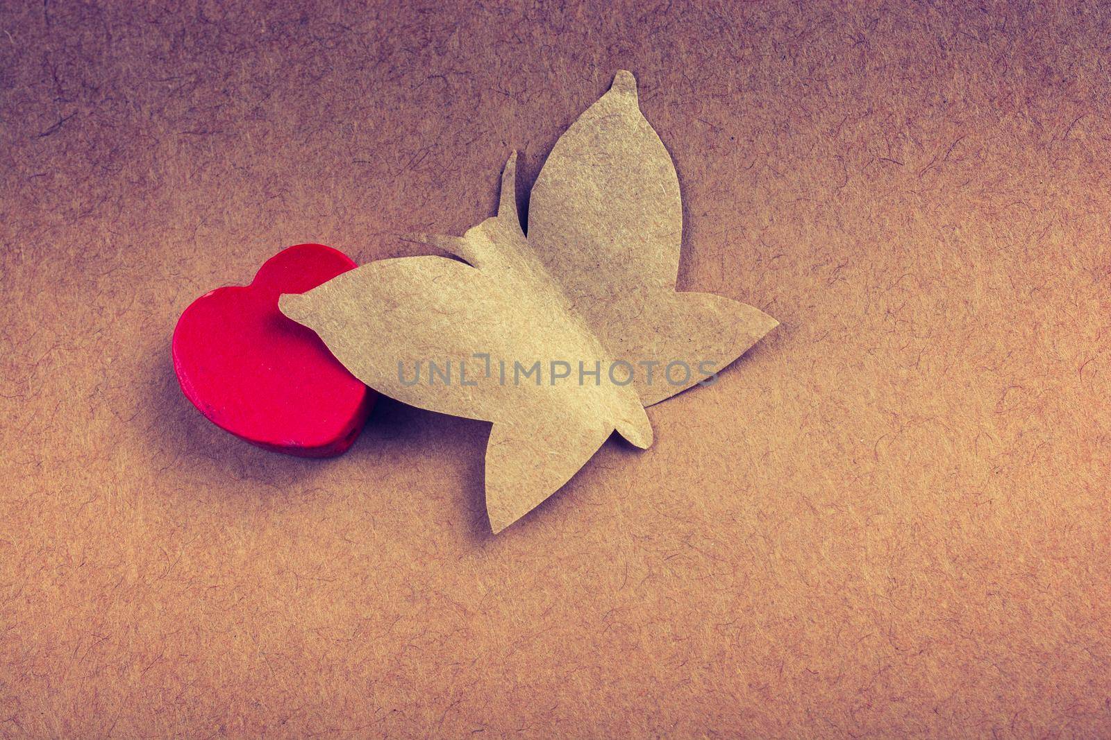 Butterfly cut of paper and red heart icon by berkay