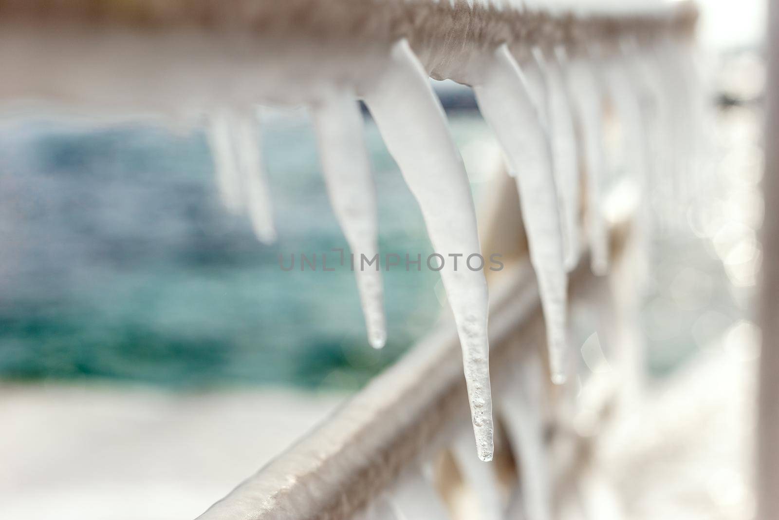 Frozen jetty with icicles on the handrails by Syvanych