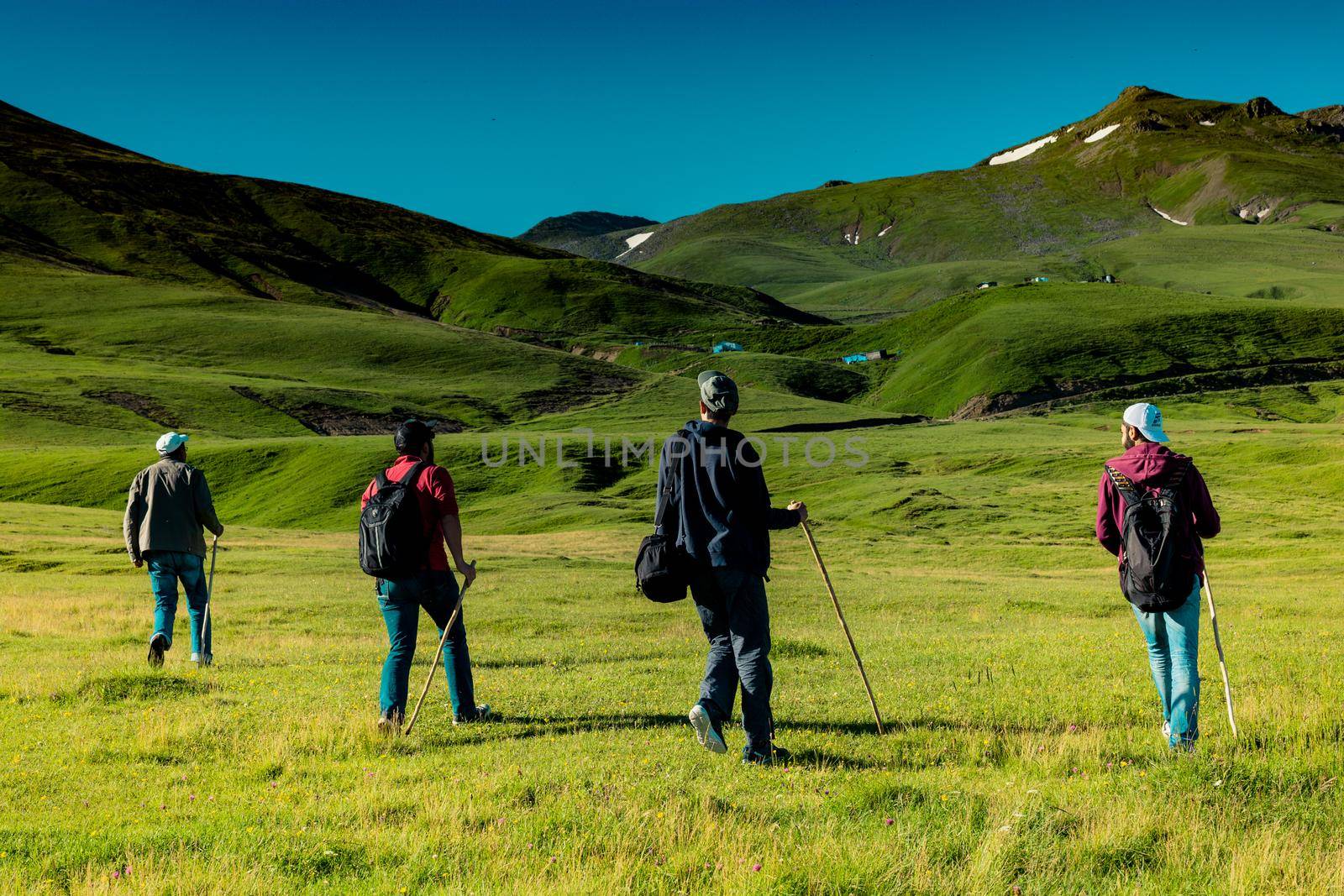 hikers with backpacks and trekking poles walking in Artvin highland by berkay